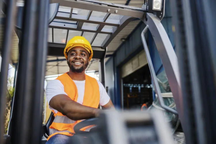 Worker driving a forklift